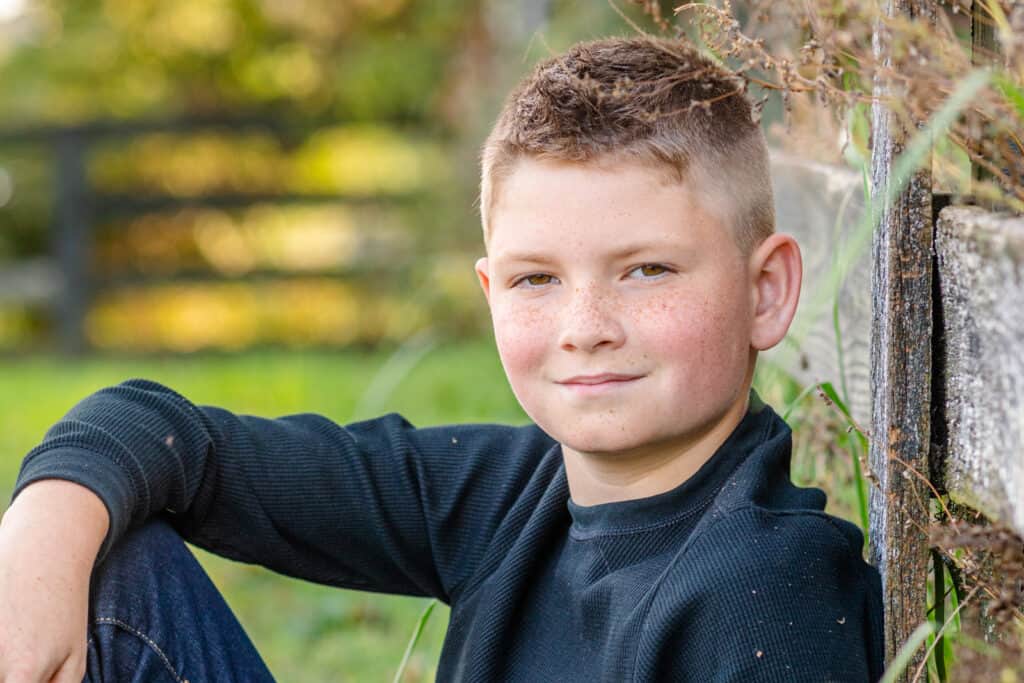 10 year old boy with black shirt and freckles closeup portrait